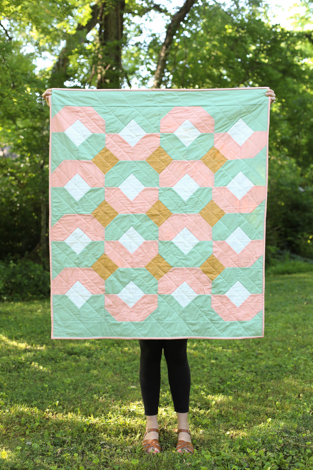 This pink and mint green baby quilt is perfect for sping! The Glitter and Glow quilt pattern comes in king through baby quilt sizes and is beginner friendly.
