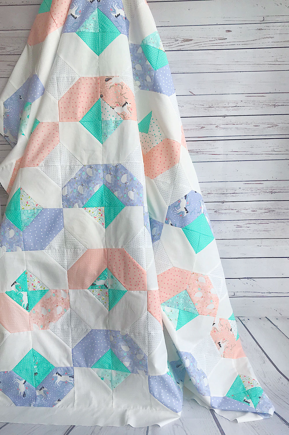 This Peach and Periwinkle Glitter quilt is so cute! Featuring ponies, swans, and sweet little flowers.