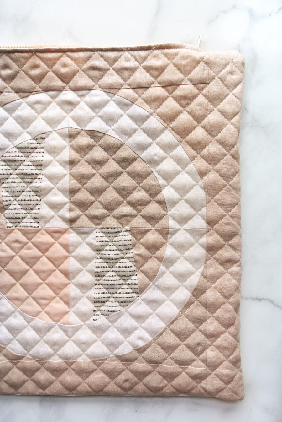 Elegant Quilted Pillow DIY! Sew a quilted zipper pillow with this step by step tutorial. I'll walk you through how to baste and quilt your pillow top, sew a zipper, and finish the pillow beautifully!