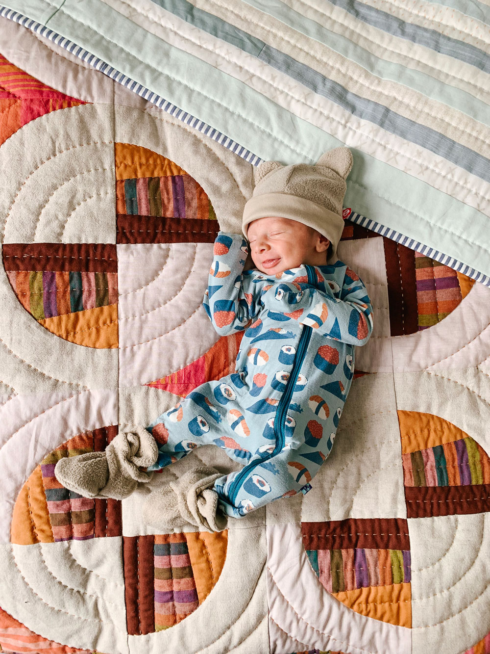 Desi on his baby Modern Fans quilt