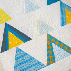 The Mod Mountains quilt pattern is fat quarter friendly and great for using fabric scraps from your stash. A video tutorial show step by step how to sew triangles. This quilt pattern includes fabric requirements for queen/full, twin, throw and baby quilt sizes.