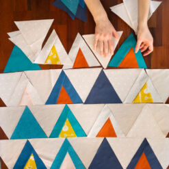 The Mod Mountains quilt pattern is fat quarter friendly and great for using fabric scraps from your stash. A video tutorial show step by step how to sew triangles. This quilt pattern includes fabric requirements for queen/full, twin, throw and baby quilt sizes.