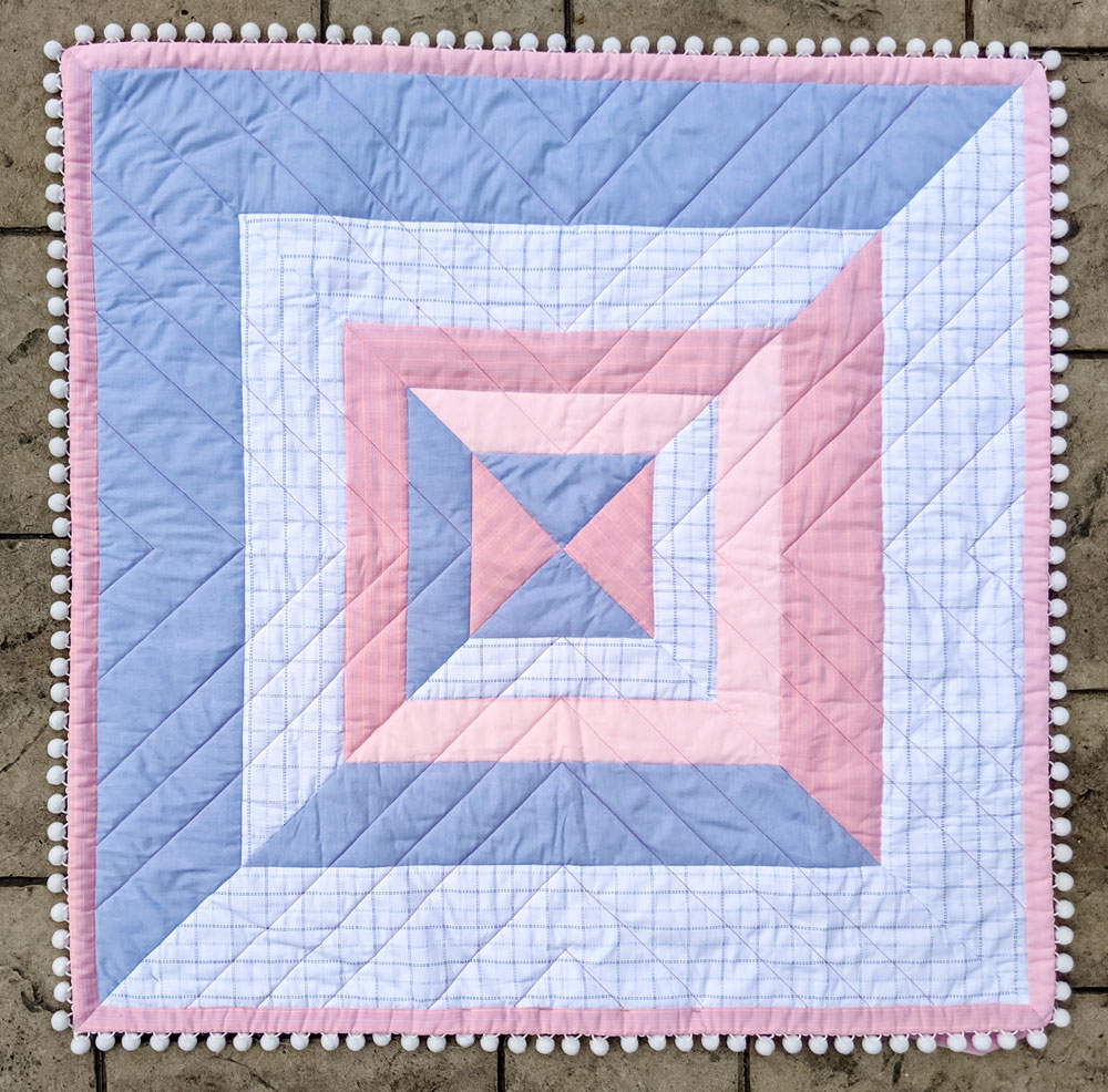 The Reflections quilt pattern is a beginner-friendly modern design that includes king, queen, full, twin, throw and baby quilt sizes.