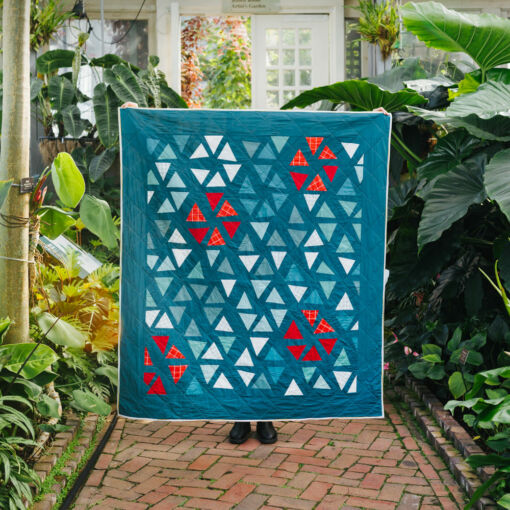 The perfect Christmas quilt pattern! The Perennial quilt pattern looks like wildflowers growing in a meadow – so use your scraps! Fat quarter and fat eighth friendly plus video tutorials! suzyquilts.com #ChristmasQuiltPattern
