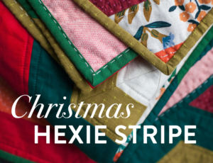 It's easy to get in the holiday spirit and get your Christmas quilting done with a pattern like Hexie Stripe. It's a vintage design with a modern twist! To make a throw all you need are 9 different 1/2 yd. cuts of fabric. Mix red and green solids with some floral prints for a beautifully festive quilt! suzyquilts.com #christmasquilt #christmassewing