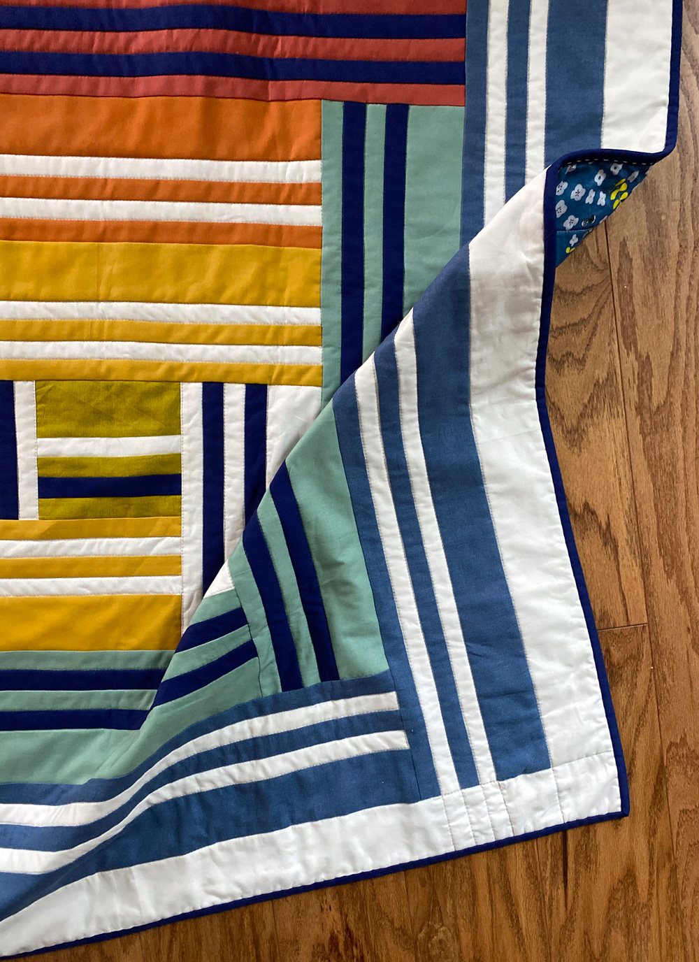 The Grow quilt pattern focuses on strip piecing – a simple quilting technique that creates a beautiful modern design. Beginner Friendly quilt pattern. See lots of quilt examples! suzyquilts.com #rainbowquilt