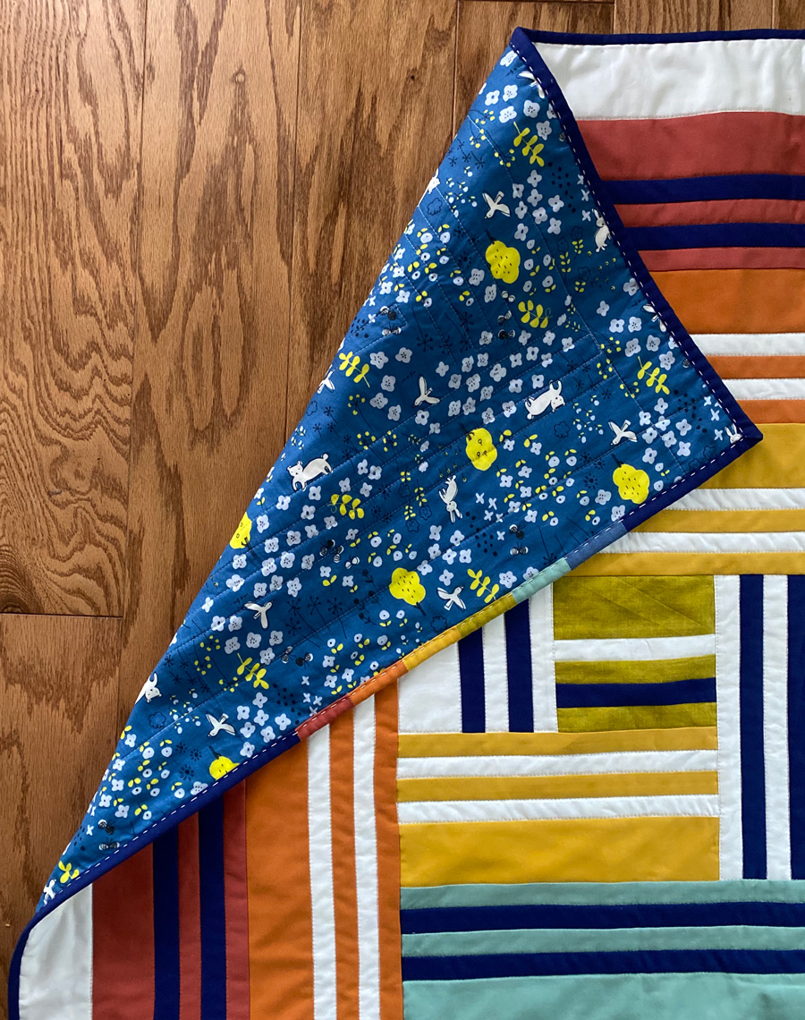 The Grow quilt pattern focuses on strip piecing – a simple quilting technique that creates a beautiful modern design. Beginner Friendly quilt pattern. See lots of quilt examples! suzyquilts.com #rainbowquilt