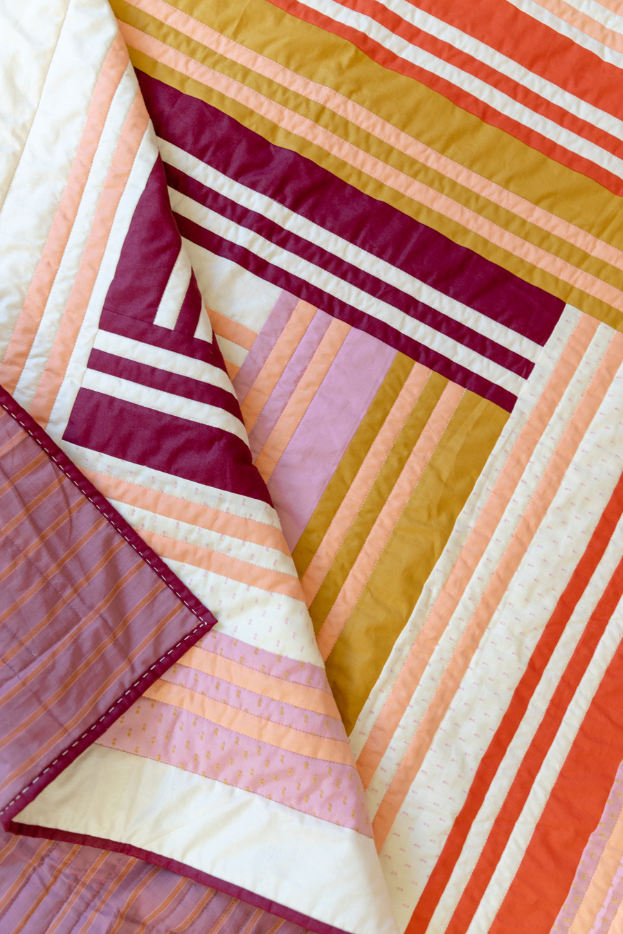 The Grow quilt pattern focuses on strip piecing – a simple quilting technique that creates a beautiful modern design. Beginner Friendly quilt pattern. See lots of beautiful quilt examples! suzyquilts.com #modernquilt