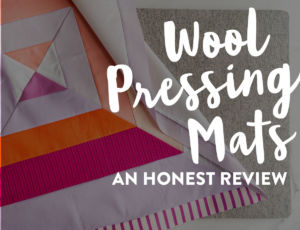 A wool pressing mat can be a wonderful tool in quilting. Portable, lightweight, and made of only natural fibers, these mats can also help iron fabric in half the time! suzyquilts.com #quilting #quiltingtools #sew
