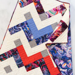 Thrive is a modern chevron motif quilt pattern PDF download. It includes king, queen/full, twin, throw and baby quilts sizes. A perfect Liberty of London baby quilt! suzyquilts.com #babyquilt