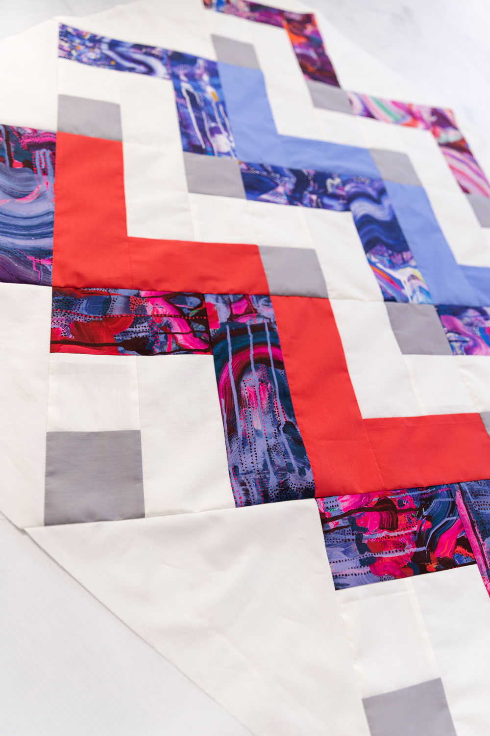 Thrive is a fat-quarter friendly modern quilt pattern using Liberty of London fabric. This instant PDF download comes in king, queen/full, twin, throw and baby quilt sizes. suzyquilts.com