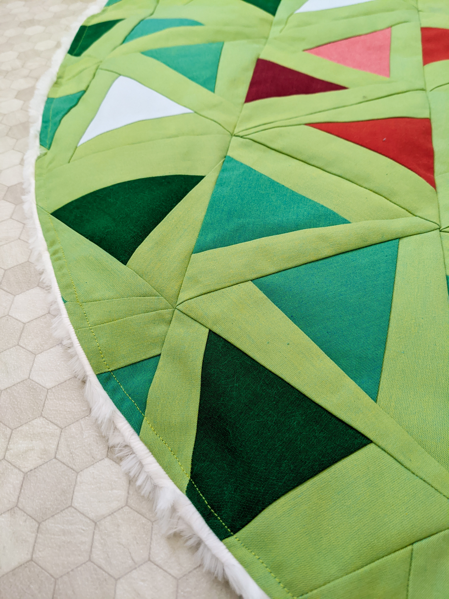 This DIY Patchwork Tree Skirt tutorial walks you through sewing a Christmas tree skirt based on the Perennial Quilt Pattern by Suzy Quilts
