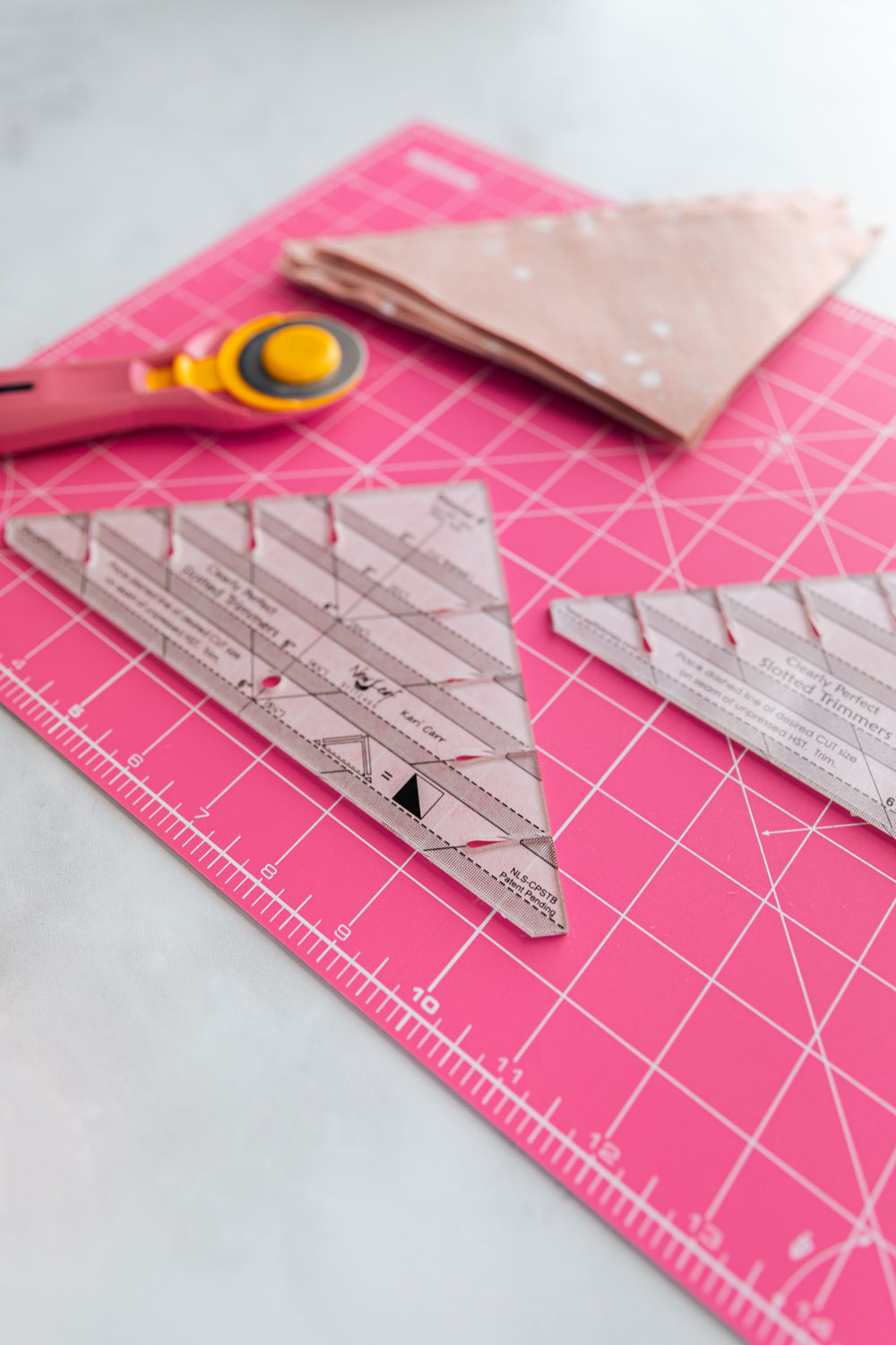 The best tutorial on how to trim half square triangles for quilting! Make perfect HSTs every time with this sewing method. suzyquilts.com #quilting #hsts