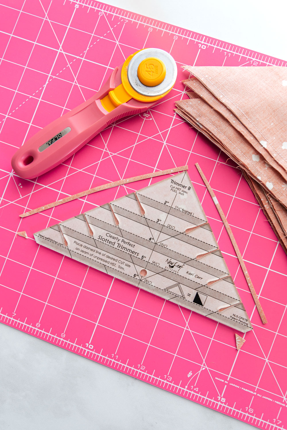 The best tutorial on how to trim half square triangles for quilting! Make perfect HSTs every time with this sewing method. suzyquilts.com #quilting #hst