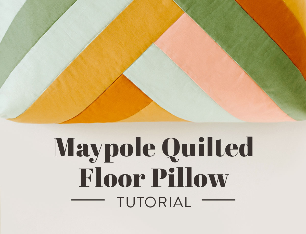 This quilted floor pillow tutorial walks you through step-by-step instructions to sew a floor pillow using the Maypole wall hanging pattern. suzyquilts.com #sewingtutorial #quiltpattern