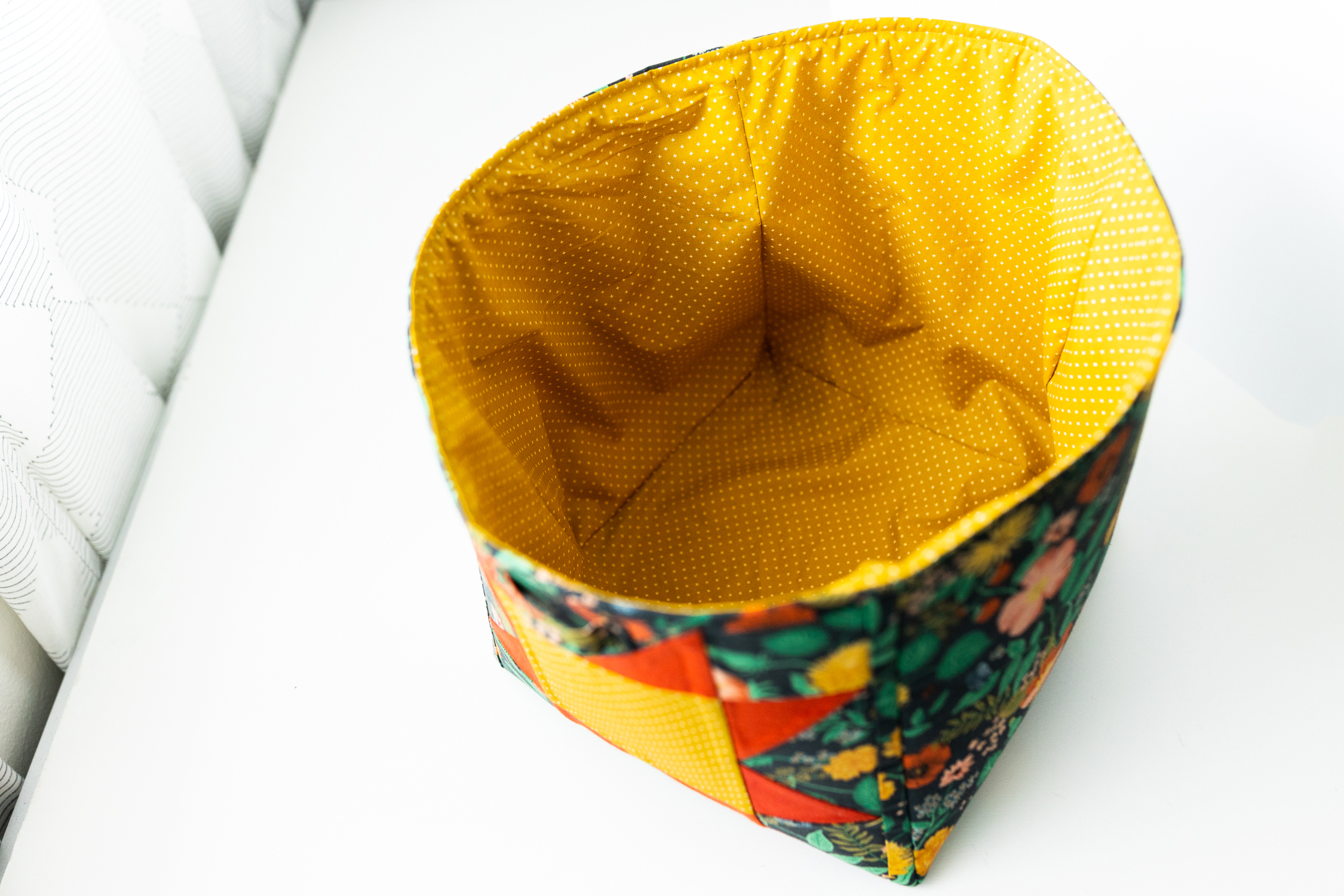 This DIY Patchwork Storage Cube Tutorial walks you through the steps of sewing a storage bin featuring a sawtooth star block