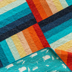 Adventureland is the best modern quilt pattern for a beginner quilter. You can use yardage, a jelly roll or scrap fabric! suzyquilts.com