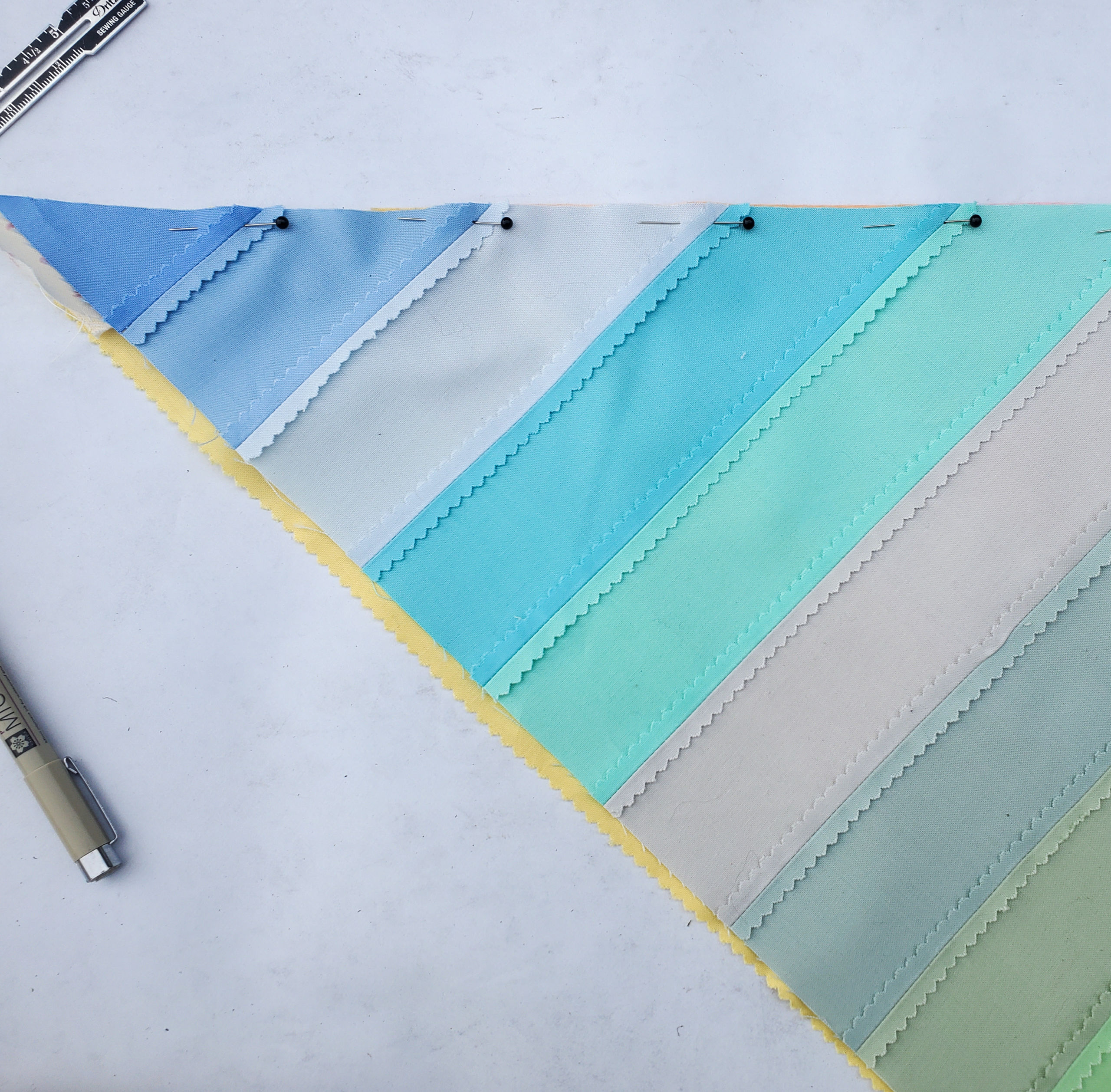 How to make a patchwork bandana with the leftover scraps from the Adventureland quilt pattern. This bandana tutorial is fast and easy! suzyquilts.com #bandana #sewingtutorial