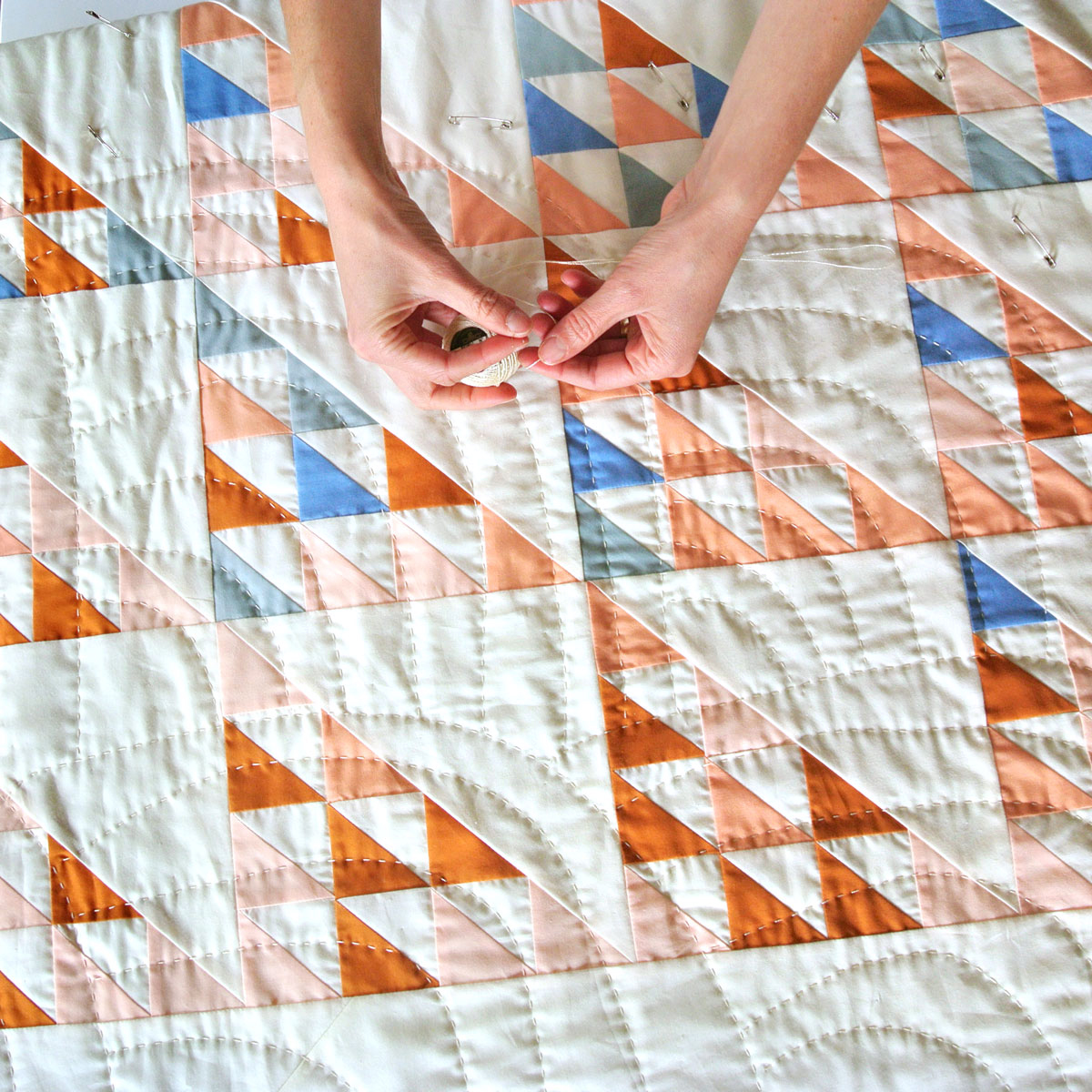 6 Steps for Mindful Making: Hands preparing to hand quilt a Fly Away quilt. #quilting suzyquilts.com