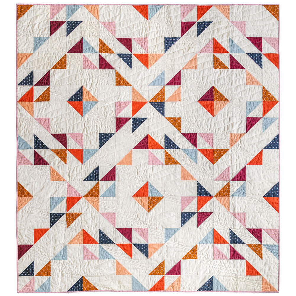 Easy Half Square Triangles Tutorial: A rainbow version of the Summer Haze pattern made using woven fabrics and a neutral background. suzyquilts.com #quilting #sewingdiy