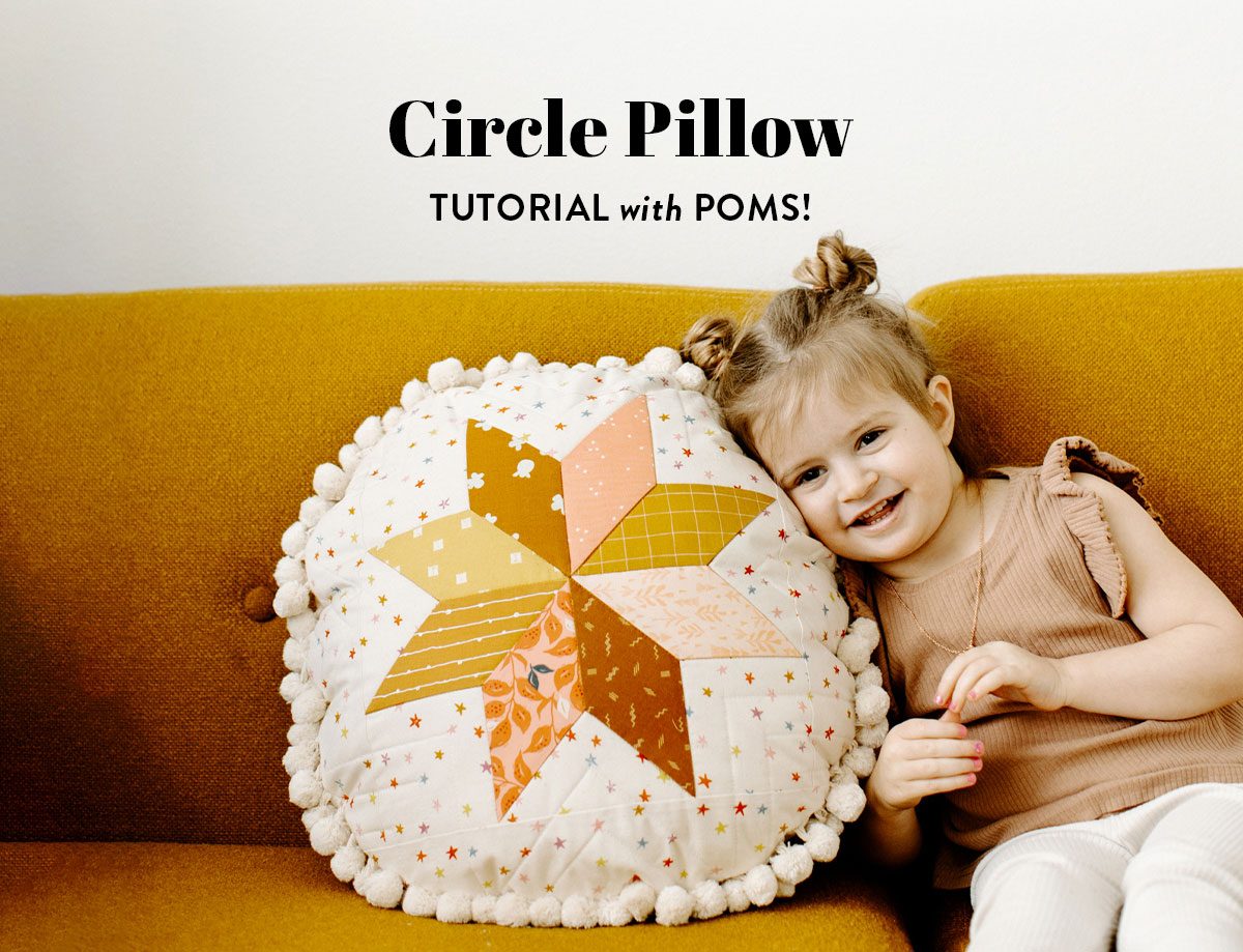 This circle pillow tutorial walks you through making a quilted star pillow using the LeMoyne star block with optional pom poms suzyquilts.com