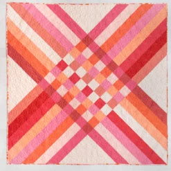 Star Crossed Quilt Pattern: A Star Crossed quilt in pink solid fabrics. #quilting suzyquilts.com