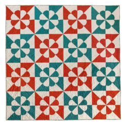 A Noel quilt in red and green fabrics. #quilting #noelquiltpattern suzyquilts.com