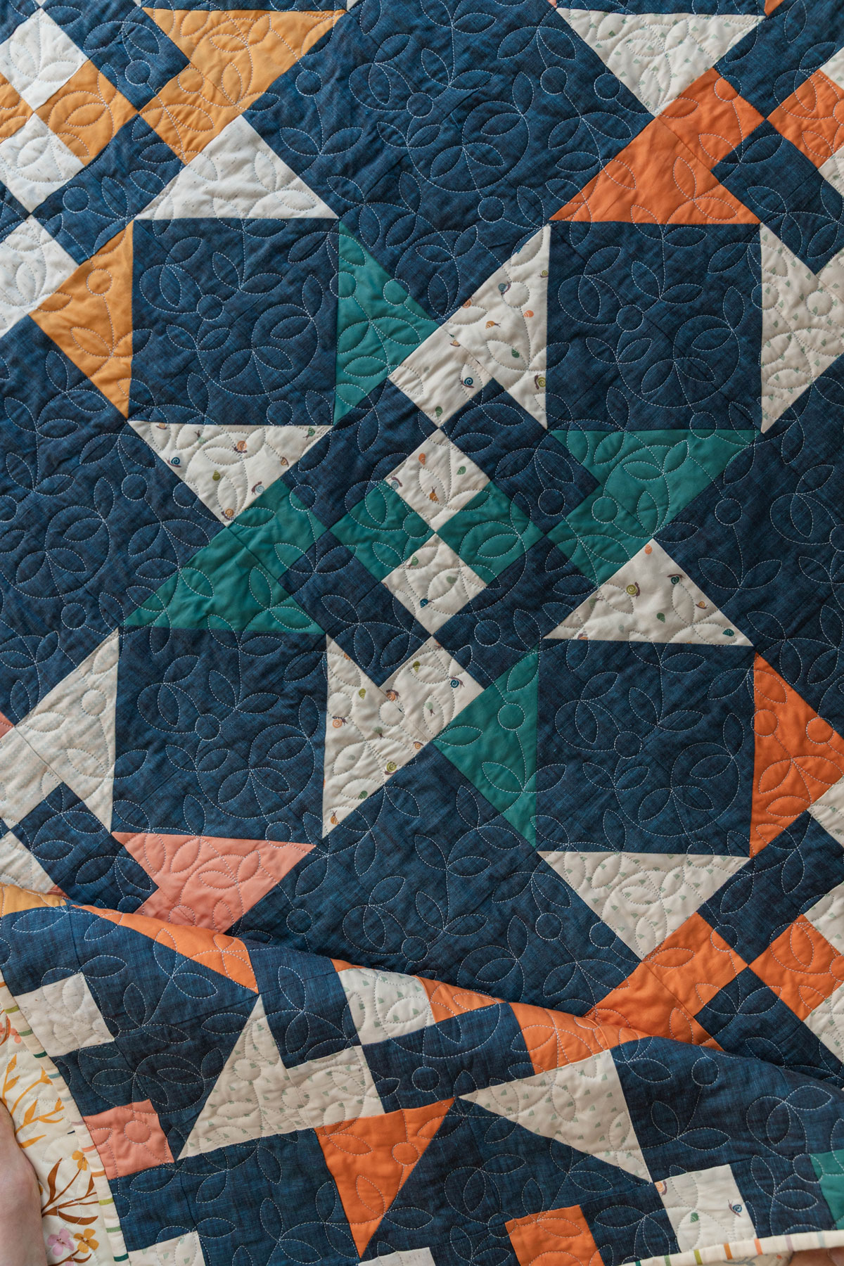 A Fat Quarter Stars quilt pattern by Suzy Quilts with a blue background and green, orange, yellow, and pink stars. #Quilting #SewingDIY suzyquilts.com A Fat Quarter Stars quilt pattern by Suzy Quilts with a blue background and green, orange, yellow, and pink stars. #Quilting #SewingDIY suzyquilts.com