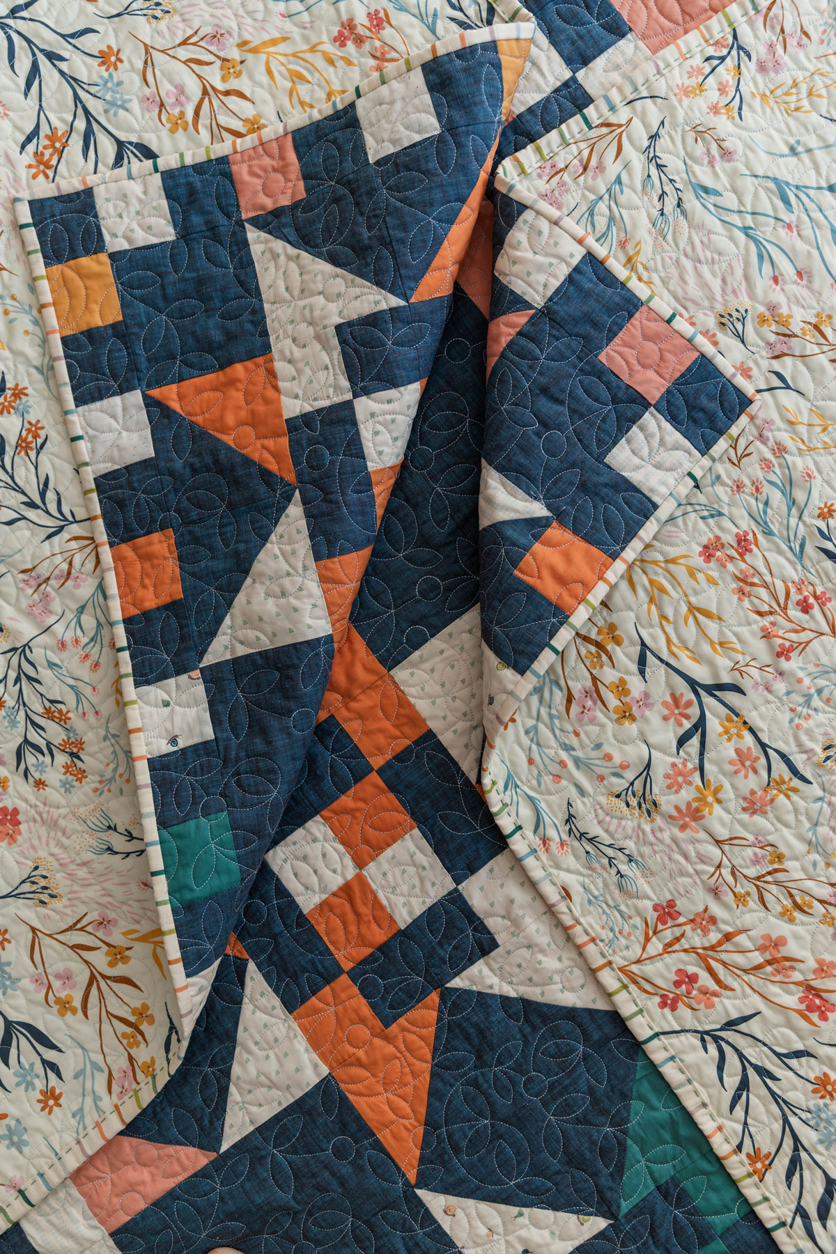 A Fat Quarter Stars quilt pattern by Suzy Quilts with a blue background and green, orange, yellow, and pink stars. #Quilting #SewingDIY suzyquilts.com A Fat Quarter Stars quilt pattern by Suzy Quilts with a blue background and green, orange, yellow, and pink stars. #Quilting #SewingDIY suzyquilts.com